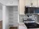 Bright kitchen features stainless steel appliances, sleek countertops, and a pantry at 449 King St, Denver, CO 80204