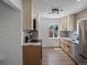 Bright kitchen featuring stainless appliances, bright cabinets, stylish backsplash, and modern countertops at 449 King St, Denver, CO 80204