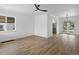 Open living space featuring wood floors, large windows, and access to the kitchen and backyard at 449 King St, Denver, CO 80204