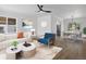 Bright living room boasts modern furnishings, an overhead fan, and seamless access to the dining area at 449 King St, Denver, CO 80204