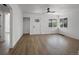 Bright living room featuring wood flooring, a ceiling fan, and natural light from the windows at 449 King St, Denver, CO 80204