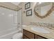 Bathroom featuring a vanity with a granite countertop and mosaic backsplash plus a tub and shower at 14034 E Utah Cir, Aurora, CO 80012