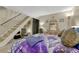 This bedroom features a staircase and a vintage vanity with a decorative mirror and hat at 14034 E Utah Cir, Aurora, CO 80012