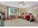 Bright bedroom with a ceiling fan, window with natural light, and a comfortable bed at 14034 E Utah Cir, Aurora, CO 80012