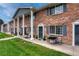 Charming brick townhome with classic architectural details and well-maintained front lawn at 14034 E Utah Cir, Aurora, CO 80012