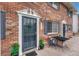 Inviting brick townhome entrance with secure screen door and outdoor seating area at 14034 E Utah Cir, Aurora, CO 80012