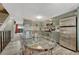 Modern kitchen features updated appliances, cabinets, and backsplash plus a glass top kitchen table with chairs at 14034 E Utah Cir, Aurora, CO 80012