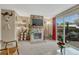 Cozy living room features a stone fireplace with a mounted TV and sliding glass doors leading to the outside at 14034 E Utah Cir, Aurora, CO 80012