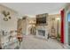 Living room featuring a stone fireplace with mounted TV, a bull skull, and a staircase at 14034 E Utah Cir, Aurora, CO 80012