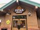 Exterior view of a Texas Roadhouse restaurant with a prominent sign at 14034 E Utah Cir, Aurora, CO 80012