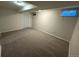Finished basement area with neutral carpet, lighting, and window at 2991 S Whiting Way, Denver, CO 80231