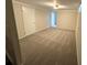 Carpeted basement area with painted walls and a window for natural light at 2991 S Whiting Way, Denver, CO 80231