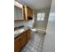 Functional bathroom design with shower-tub combo, vanity, and tiled floors at 2991 S Whiting Way, Denver, CO 80231