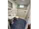 Updated bathroom with modern fixtures, tiled shower, and blue tiled flooring at 2991 S Whiting Way, Denver, CO 80231