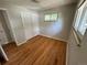 Bright bedroom featuring hardwood floors, a window, and a closet with sliding doors at 2991 S Whiting Way, Denver, CO 80231