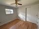 Cozy bedroom featuring hardwood floors, a ceiling fan, and a sliding-door closet at 2991 S Whiting Way, Denver, CO 80231