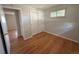 Bedroom with hardwood floors, a sliding-door closet, and a window offering ample natural light at 2991 S Whiting Way, Denver, CO 80231