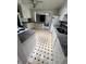 Cozy kitchen with white cabinets, granite countertops, and an eye-catching black and white tiled floor at 2991 S Whiting Way, Denver, CO 80231
