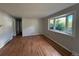 Bright living room featuring hardwood floors and a large bay window with natural light and outdoor views at 2991 S Whiting Way, Denver, CO 80231