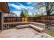 Back deck featuring built-in seating and wooden railings overlooking the yard at 7500 E Dartmouth Ave # 16, Denver, CO 80231