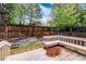 Back deck featuring built-in seating and wooden railings overlooking the backyard at 7500 E Dartmouth Ave # 16, Denver, CO 80231