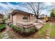 Backyard showcasing a wooden deck, green bushes, and a lush lawn at 7500 E Dartmouth Ave # 16, Denver, CO 80231