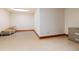 A cozy basement area featuring a chair and a filing cabinet against white walls at 7500 E Dartmouth Ave # 16, Denver, CO 80231