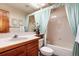 Well-lit bathroom features a vanity, toilet, and bathtub with shower at 7500 E Dartmouth Ave # 16, Denver, CO 80231