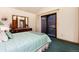 Bright bedroom featuring an ensuite balcony, dark furniture, and pale green accents at 7500 E Dartmouth Ave # 16, Denver, CO 80231