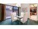 Elegant dining area featuring a glass-top table with contemporary chairs and ample natural light at 7500 E Dartmouth Ave # 16, Denver, CO 80231