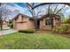 Charming brick home featuring an attached garage and a well-maintained lawn at 7500 E Dartmouth Ave # 16, Denver, CO 80231