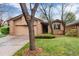 Charming brick home with mature landscaping, a lawn, and an attached garage at 7500 E Dartmouth Ave # 16, Denver, CO 80231