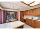 Bright eat-in kitchen with wooden cabinets, white countertops, and a cozy dining area by the window at 7500 E Dartmouth Ave # 16, Denver, CO 80231