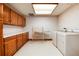 Laundry room featuring washer, dryer, cabinets, and folding rack at 7500 E Dartmouth Ave # 16, Denver, CO 80231