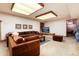 Basement living area with comfortable brown sofa and flat-screen TV at 7500 E Dartmouth Ave # 16, Denver, CO 80231