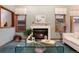 Cozy living room featuring a fireplace, large windows, and elegant decor at 7500 E Dartmouth Ave # 16, Denver, CO 80231