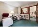 Comfortable living room with plush seating, vintage decor, and an open view to adjacent rooms through a wall cut out at 7500 E Dartmouth Ave # 16, Denver, CO 80231