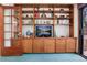 Living room boasts a custom built-in shelving unit with closed cabinets and a variety of decoratives and electronics at 7500 E Dartmouth Ave # 16, Denver, CO 80231