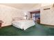 Cozy main bedroom featuring neutral walls, a large bed, and a sliding glass door at 7500 E Dartmouth Ave # 16, Denver, CO 80231