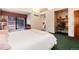 Spacious main bedroom featuring an ensuite office, a sitting area, and neutral walls at 7500 E Dartmouth Ave # 16, Denver, CO 80231