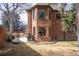 Brick home's backyard featuring an outdoor patio set, a basketball hoop, and green grass at 290 Dexter St, Denver, CO 80220