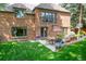 Lovely backyard with brick home exterior, patio dining, and lush green lawn at 290 Dexter St, Denver, CO 80220