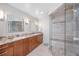 Beautiful bathroom with a glass shower, granite counters, double sinks, and wood cabinetry at 290 Dexter St, Denver, CO 80220