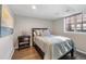 Neutral bedroom with hardwood flooring, a side table, and a window that provides natural light at 290 Dexter St, Denver, CO 80220