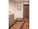Entryway area featuring wood floors, a bench with drawers, cabinets, and a dark brown door at 290 Dexter St, Denver, CO 80220