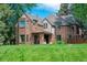 Beautiful brick home with manicured lawn and mature trees providing shade and curb appeal at 290 Dexter St, Denver, CO 80220