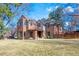Charming two-story brick home with a manicured front lawn and a welcoming covered entrance at 290 Dexter St, Denver, CO 80220