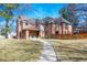 Stately brick residence with gabled rooflines, mature trees, and a stone walkway leading to the front entrance at 290 Dexter St, Denver, CO 80220