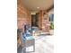 Inviting front porch with wicker seating, brick accents, and a view of the double front doors at 290 Dexter St, Denver, CO 80220