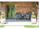 Inviting front porch with brick facade, seating, and elegant double door entrance at 290 Dexter St, Denver, CO 80220